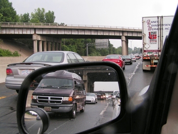 This photo showing different types of vehicles "through a mirror" was taken by an unknown photographer.